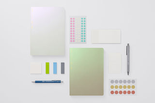 Collection of stationery items including a pen, sticky notes, and color stickers on a white background