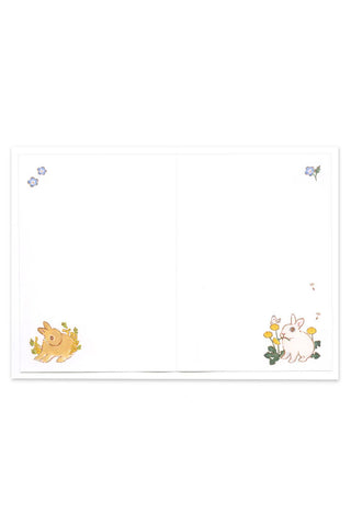 Inside of greeting card showing small illustrations rabbits and flowers on a white background