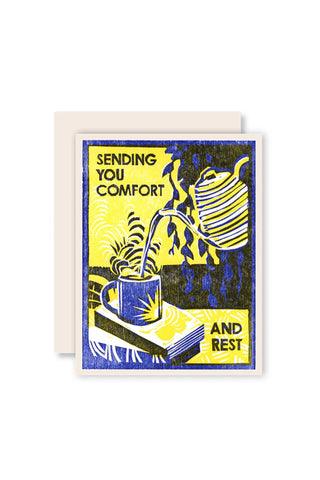Greeting card with illustration of a teapot, cup, and books, and text 'Sending you comfort and rest' on a white background.