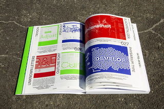 Open magazine with design pages on a textured surface