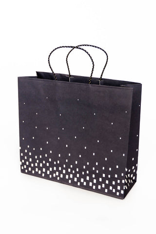 Black paper bag with white geometric pattern on a white background