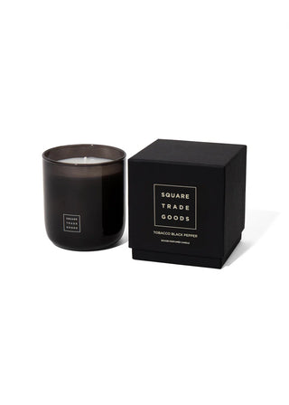 Black candle in a matching container with 'Square Trade Goods' branding on a white background