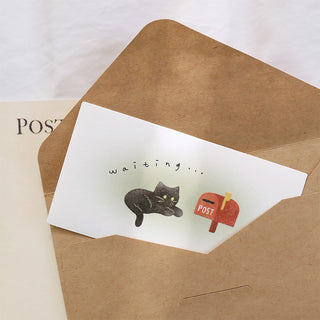Paper envelope with “waiting...” text and black cat “post” sticker