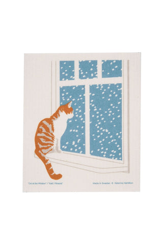 Swedish dishcloth with print of cat looking out a window with snow falling