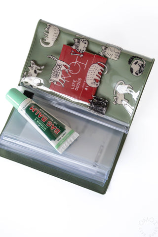 Opened green cat design 5 pocket pouch with lip balm and matches on a white background