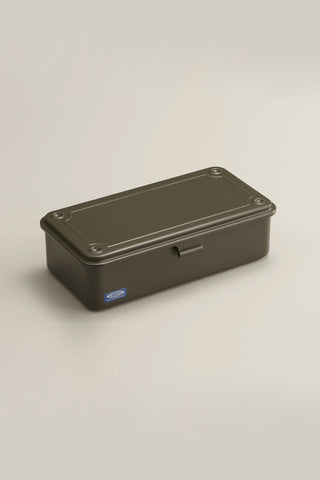 Olive green metal box with a handle on a beige background