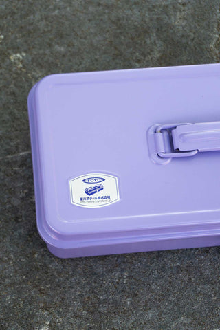 Purple toolbox with a visible brand logo on a dark surface