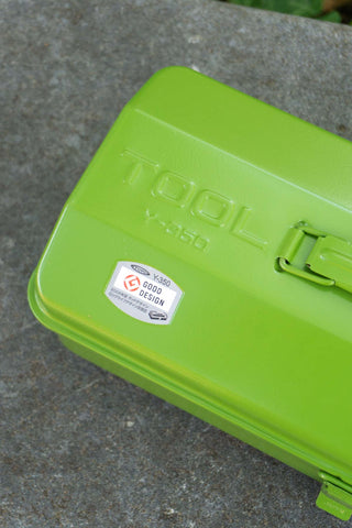 Green toolbox on a concrete surface