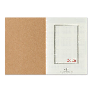 Open notebook of TRAVELER'S monthly planner that reads 2026