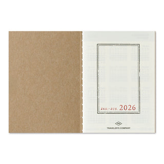 Opened 2026 planner with brown and white design, featuring 'Traveler's Company' branding.