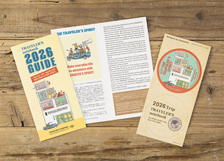 2026 guidebook and travel notebook on a wooden surface