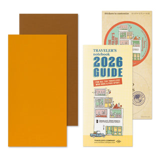 Traveler's notebook 2026 Guide with orange and brown covers on a white background
