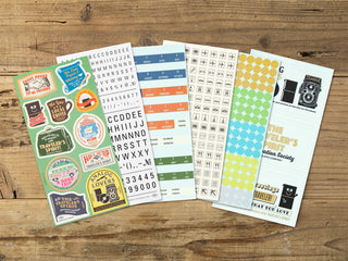 Collection of planner stickers on a wooden surface