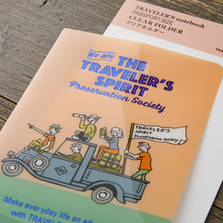 File folder with 'Traveler's Spirit Preservation Society' illustration on a wooden surface