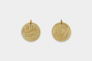 Two gold charms on a white background