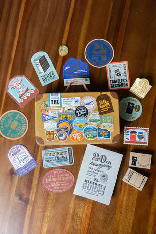 Collection of stickers and tin trunk a wooden surface