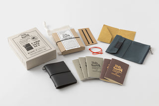 Collection of leather wallets and notebooks on a white background