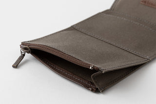 Brown open zipper case on a light gray background