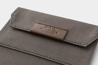 Brown pouch with a brown leather patch displaying '20th TRAVELER'S notebook' branding.