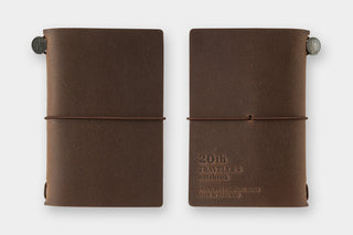 Two brown leather notebooks on a white background