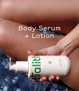 Body balm bottle held in hand with white pump, green label on beige container