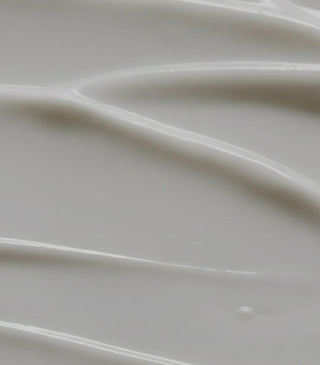 Thick white cream balm with smooth, swirled texture