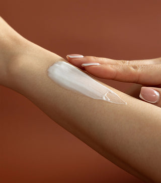White balm cream applied as a smooth streak on the forearm