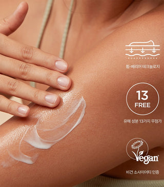 White body balm spread on skin on arm, glossy cream layer