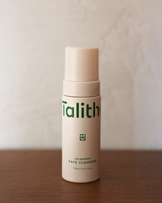 Beige face cleanser pump bottle with green logo label