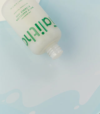 Talitha Koum essence soo bottle underside close-up, green text and white pump cap