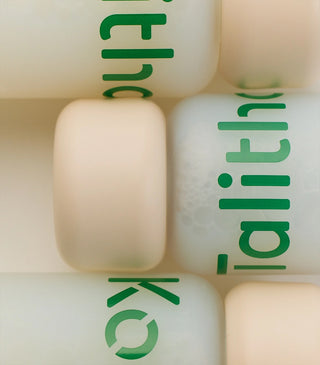 Talitha Koum essence soo bottles close-up showing white caps and green logo