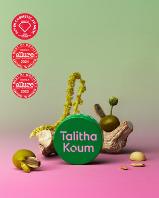 Talitha Koum lipcure balm tin with green cap on a flat surface
