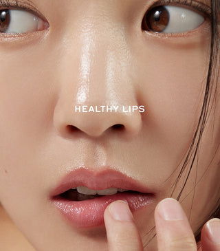 Talitha Koum Lipcure Balm on lips with fingers smoothing