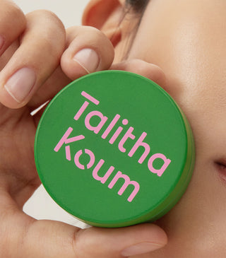 Talitha Koum Lipcure Balm green jar held near face