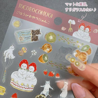 Transparent sticker sheet with cute illustrations held by a hand