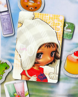 Card with a cartoon character wearing a white hood on a colorful background