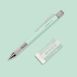 Mint green pencil and its packaging on a light green background