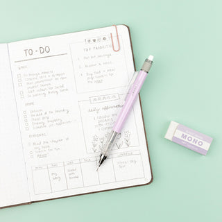 Open planner with to-do list on a light green background, featuring a pencil and eraser.
