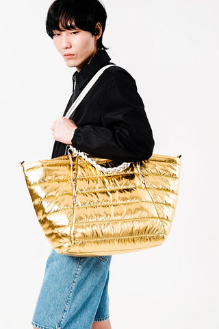 Grey braided rope strap with loop handles on gold quilted tote bag