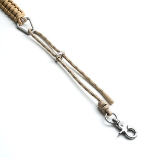 A close-up of a tan braided rope strap with silver metal hardware, and a loop clasp, on a white background.