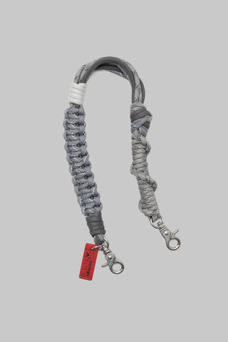 A gray braided rope strap with silver metal snap hooks on both ends on a light gray background.