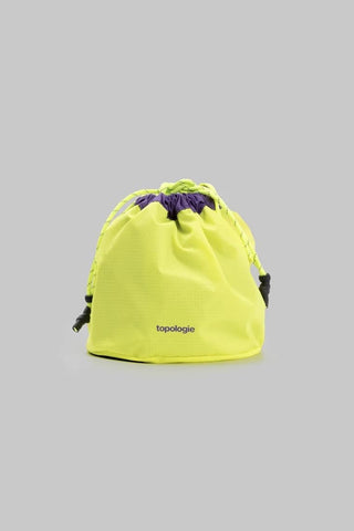Yellow drawstring bag with purple drawstring on a gray background