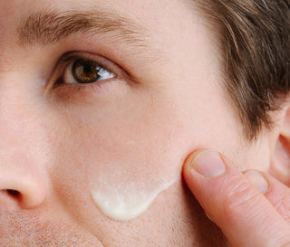 Close up of person applying face serum