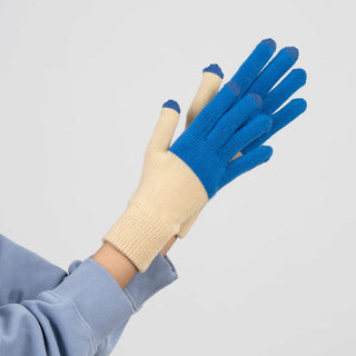 Hand wearing beige and blue gloves with touch screen tips on a light gray background