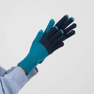 Pair of blue and black gloves on a light gray background