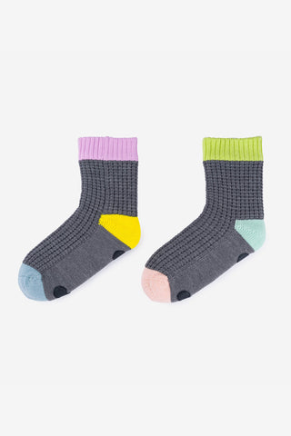 Pair of gray socks with colorful accents on a white background