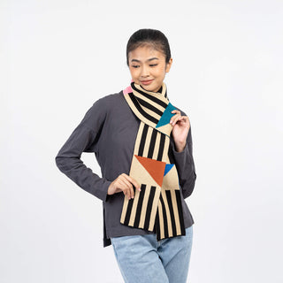 Woman wearing a colorful geometric scarf on a white background