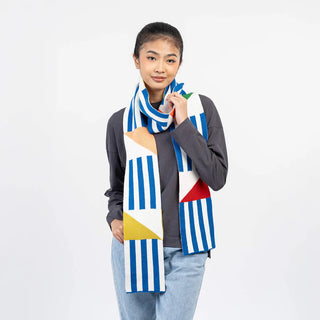 Person wearing a colorful geometric-patterned scarf on a white background