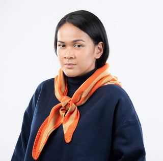 Woman wearing an orange scarf on a white background