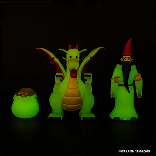 Glow in the dark dragon and wizard figures with a pot of gold on a black background